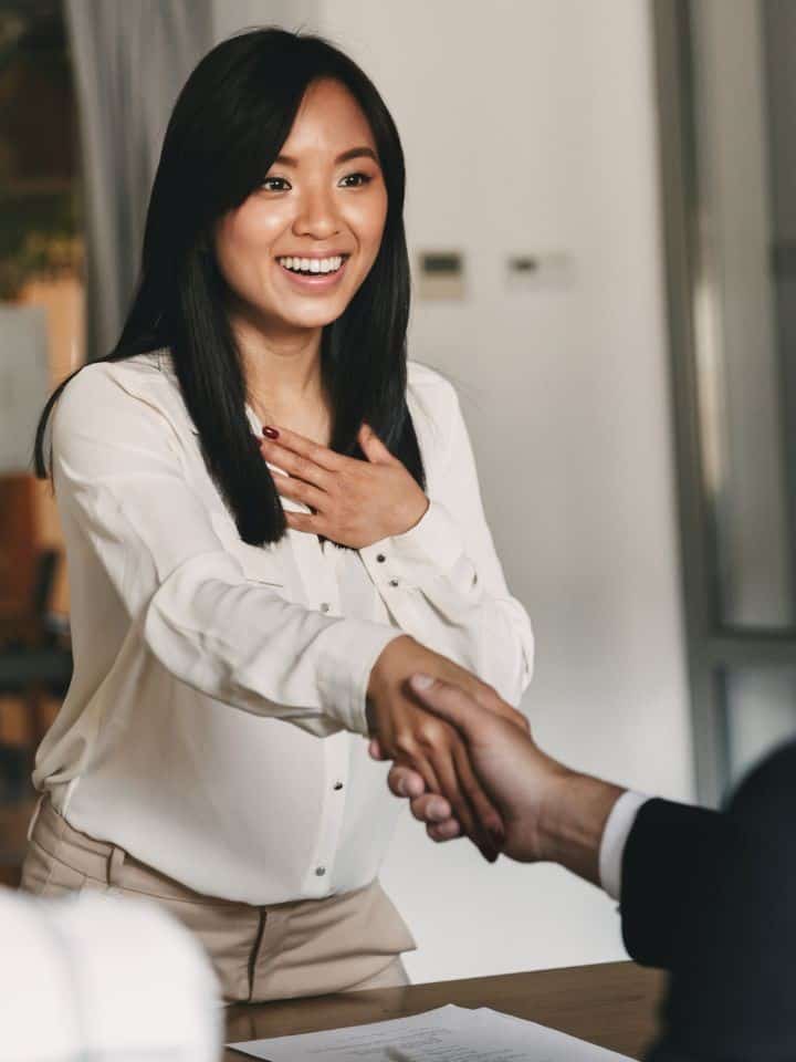 woman shaking hands, small business showcase magazine